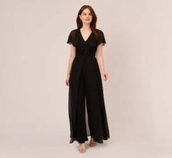 Adrianna Papell Jersey Jumpsuit With Chiffon Capelet And Skirt Overlay In Black